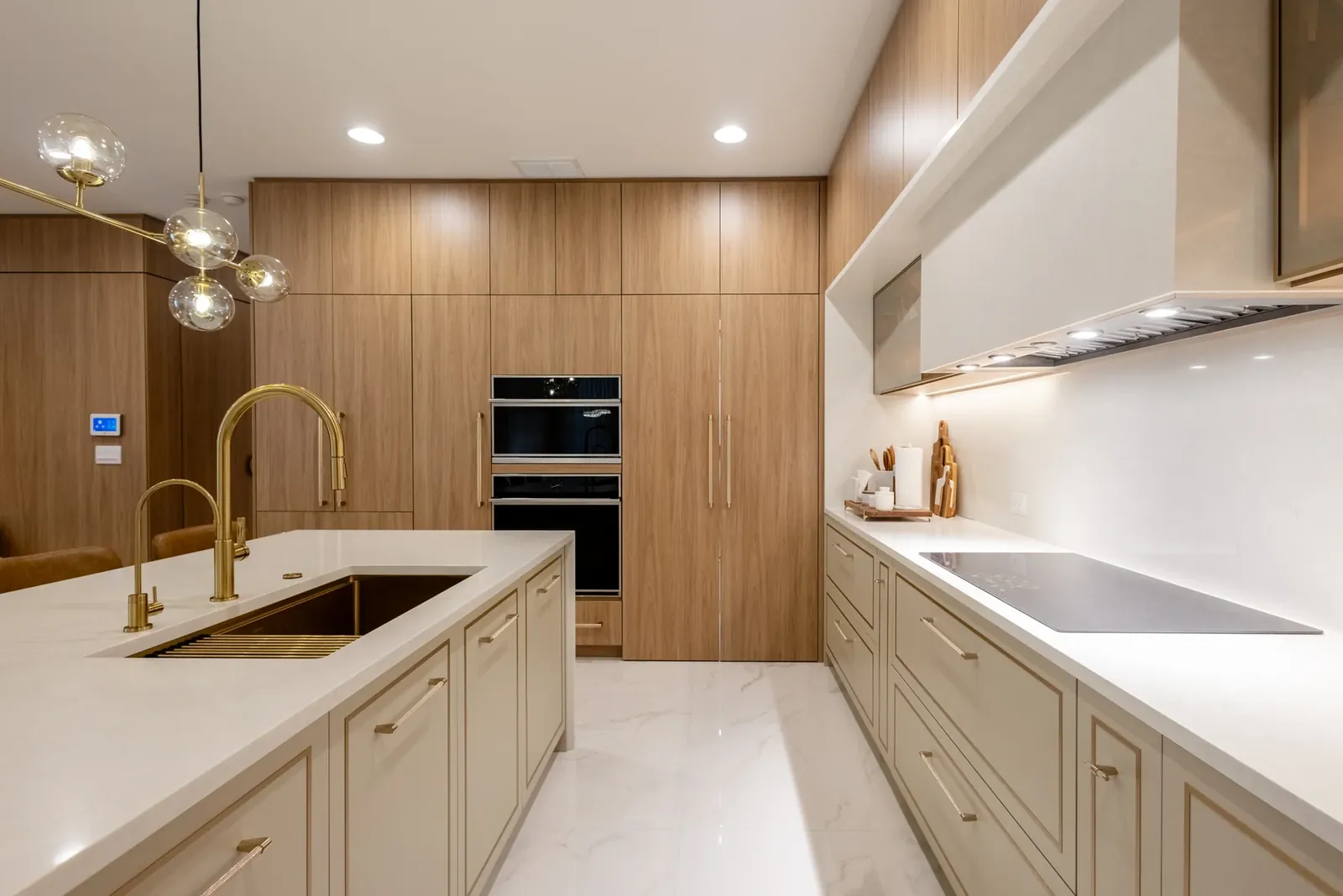 Oak and cream kitchen with brass fixtures and integrated appliances